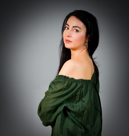 Portrait of a beautiful woman with black hair and green eyesの写真素材