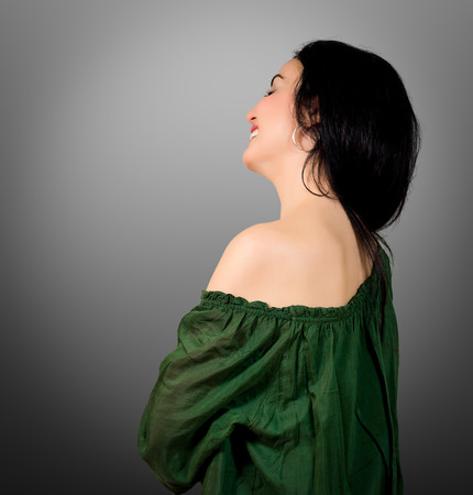 Portrait of a beautiful woman with black hair and green eyesの写真素材
