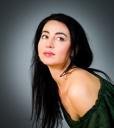 Portrait of a beautiful woman with black hair and green eyesの写真素材