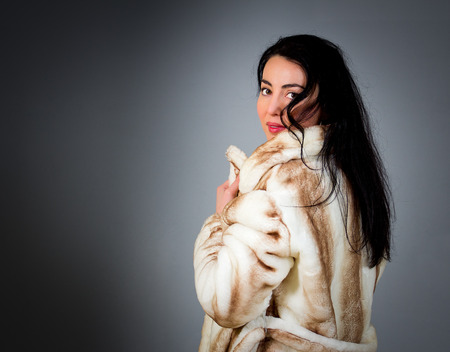 Portrait of a beautiful woman with black hair and green eyesの写真素材