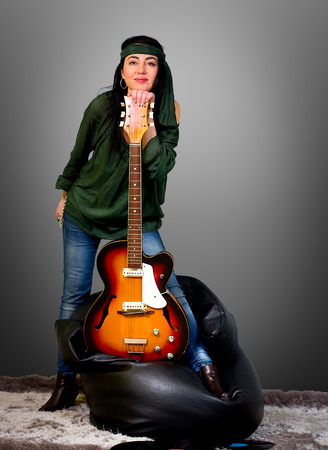 Woman posing with an electric guitarの写真素材