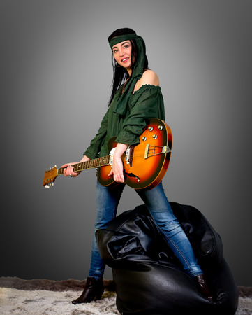 Woman posing with an electric guitarの写真素材
