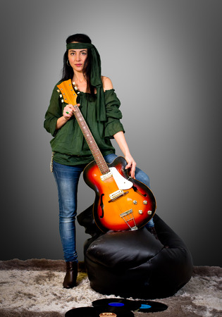 Woman posing with an electric guitarの写真素材