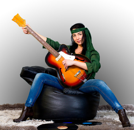 Woman posing with an electric guitarの写真素材