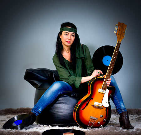 Woman posing with an electric guitarの写真素材