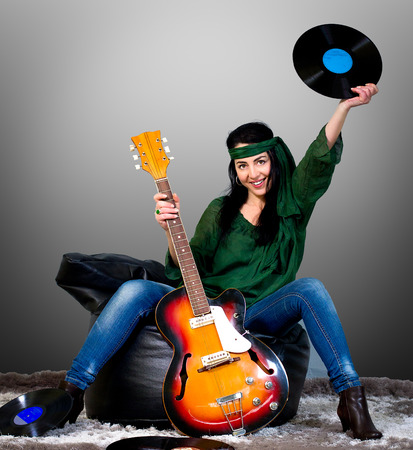 Woman posing with an electric guitarの写真素材