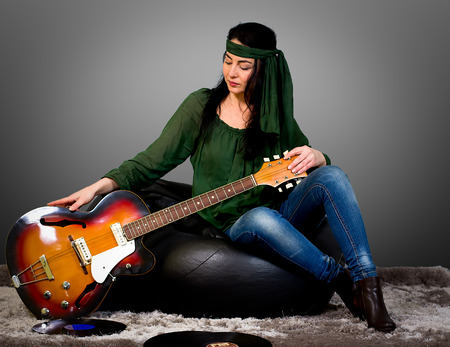 Woman posing with an electric guitarの写真素材