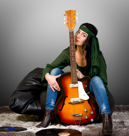 Woman posing with an electric guitarの写真素材