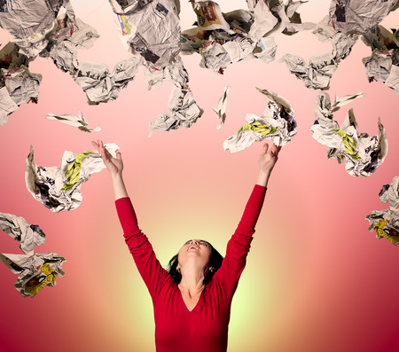 Woman throwing papers in airの写真素材