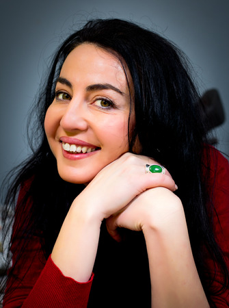 Portrait of a beautiful woman with black hair and green eyesの写真素材