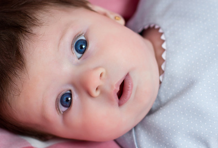 Portrait of a little baby girl with blue eyesの写真素材