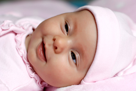 Portrait of a baby baby lying in bedの写真素材