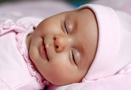 Portrait of a baby sleeping in bedの写真素材