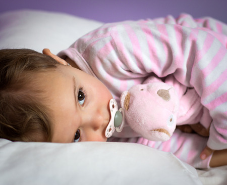 Portrait of a baby sleeping in bed