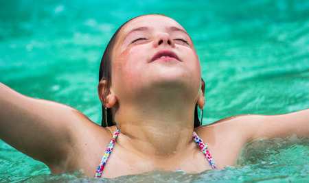 Portrait of a little girl in a pool