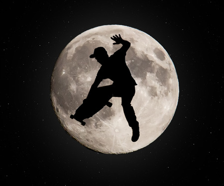 Skater jumping over the moonの写真素材