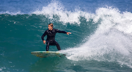 GIJON, SPAIN  Sep, 2014:  Young athletes surfing on a beach located on the outskirts of GijÃ³n. Spain. September 28, 2014のeditorial素材