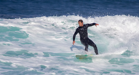 GIJON, SPAIN  Sep, 2014:  Young athletes surfing on a beach located on the outskirts of GijÃ³n. Spain. September 28, 2014のeditorial素材