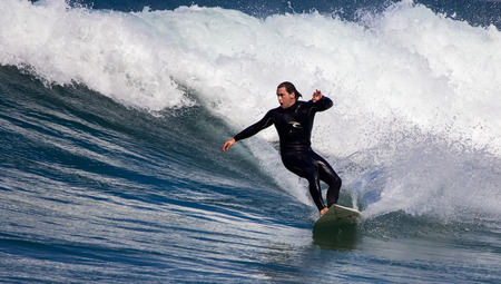 GIJON, SPAIN  Sep, 2014:  Young athletes surfing on a beach located on the outskirts of GijÃ³n. Spain. September 28, 2014のeditorial素材