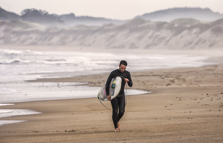 Surfer out of the water after surfing