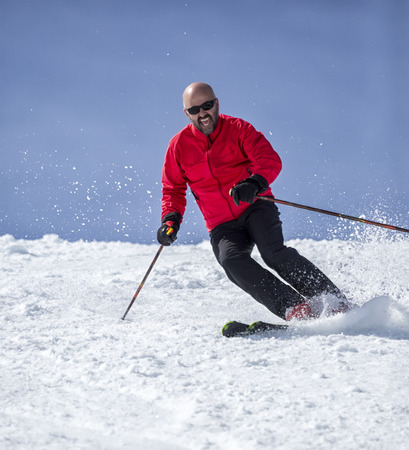 Veteran skier sliding down the slopesの写真素材