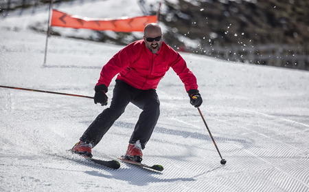 Veteran skier sliding down the slopes