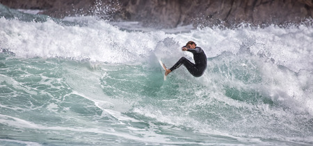 LLANES, SPAIN  May, 2015: Surfer participating in the CACONTEST 2015 on Ballota beach located in Asturias, in the north of Spain. May, 16, 2015のeditorial素材