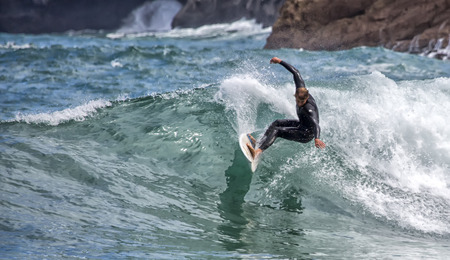 LLANES, SPAIN  May, 2015: Surfer participating in the CACONTEST 2015 on Ballota beach located in Asturias, in the north of Spain. May, 16, 2015のeditorial素材