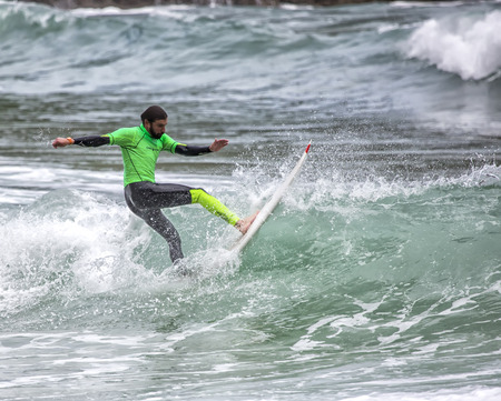 LLANES, SPAIN  May, 2015: Surfer participating in the CACONTEST 2015 on Ballota beach located in Asturias, in the north of Spain. May, 16, 2015のeditorial素材
