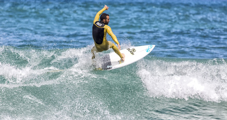 LLANES, SPAIN  May, 2015: Surfer participating in the CACONTEST 2015 on Ballota beach located in Asturias, in the north of Spain. May, 16, 2015のeditorial素材