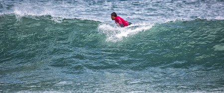 LLANES, SPAIN  May, 2015: Surfer participating in the CACONTEST 2015 on Ballota beach located in...