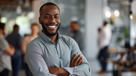Portrait of a handsome smiling black businessman boss standing in his modern business company office.の素材
