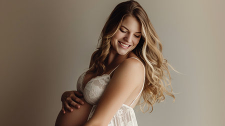 Expectant Mother in Lace Lingerie Embracing Her Pregnancyの素材