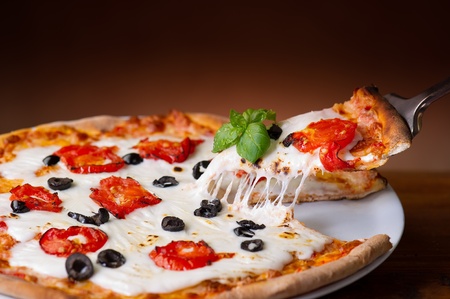 slice pizza  with buffalo mozzarella on wood backgroundsの写真素材