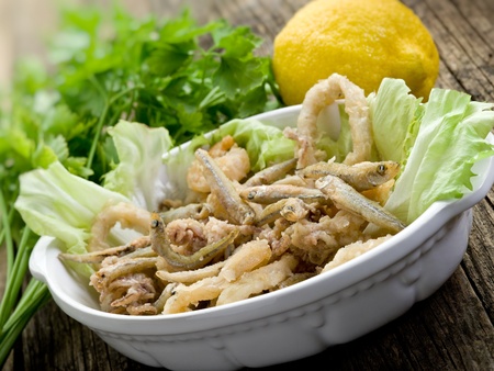 fried fish squid and shrimp with green saladの写真素材