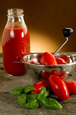 food mill with tomatoes and basilの写真素材