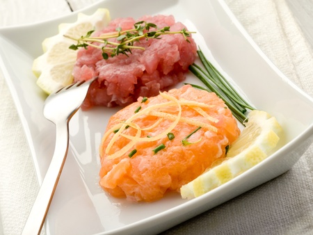 salmon and tuna tartare with lemon and chiveの写真素材