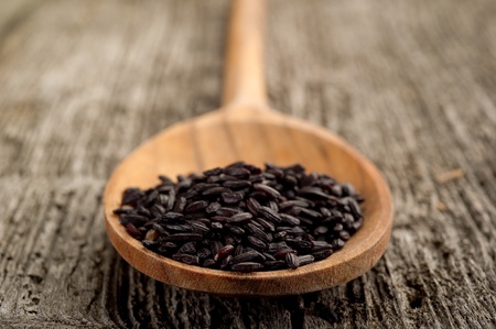 black rice on wood backgroundの写真素材