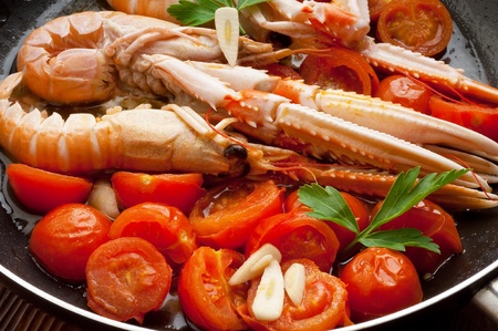 norway lobster with sliced cherry tomatoesの写真素材