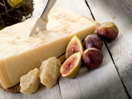 parmesan cheese over cutting board and figsの写真素材