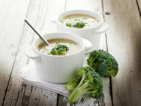 broccoli soup on bowl over wood backgrounの写真素材