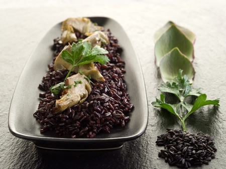 risotto with black rice and artichokeの写真素材