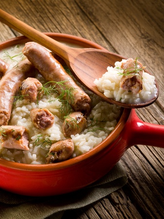 risotto with sausage over red casseroleの写真素材