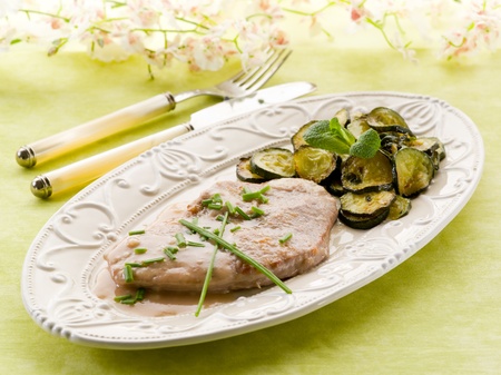 escalope with white wine sauce and sauteed zucchinisの写真素材