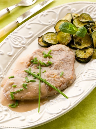 escalope with white wine sauce and sauteed zucchinisの写真素材