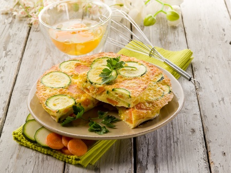 omelette with carrot zucchinis and parsleyの写真素材