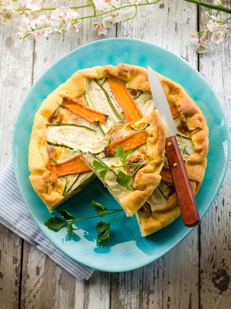vegetables cake over dish on wood backgroundの写真素材