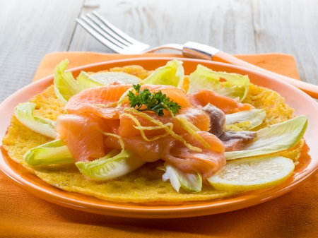 maize pancake with endive salad and smoked salmonの写真素材