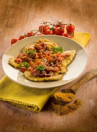 escalope with curry onions and tomatoesの写真素材