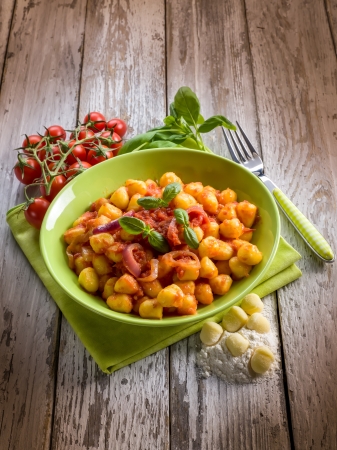 homemade gnocchi with tomato sauce basil and onionsの写真素材